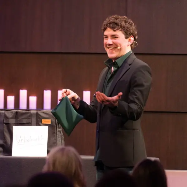 Jackson performing the cups and balls illusion
